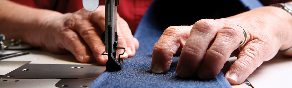 A pair of hands shown sewing a Rifton Equipment product.