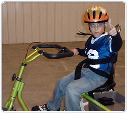 Boy on a Rifton Adaptive Tricycle