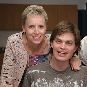 Dr. Karen McCain throws an arm around TBI recovery patient Sean Carter for an all smiles close-up.