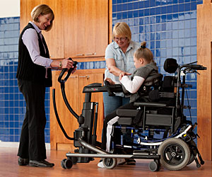 Two therapists work with a patient in the TRAM on partial weight-bearing skills