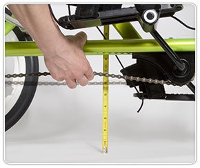 Checking chain tension on Rifton special needs trike for kids