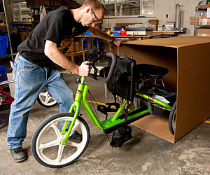 A Rifton factory worker prepares an adaptive tricycle for Variety the Children's Charity giveaway