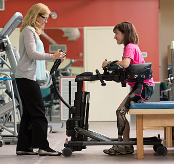 A patient uses the Rifton TRAM for sit to stand in the transfer mobility device video