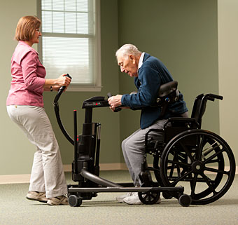 An aging man at home using the Rifton TRAM to go from sitting to standing