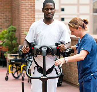A rehab patient ambulates in a Rifton TRAM vs a Hoyer lift