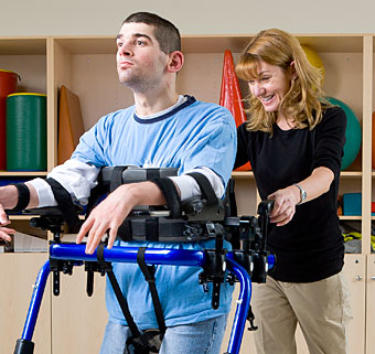 A high school graduate practices gait training for the commencement ceremony