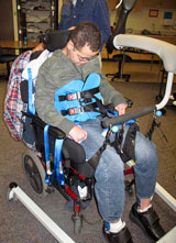 A therapist uses the SoloLift and then a TRAM to transfer a TBI patient.