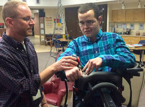 A TBI patient, with the assistance from a therapist, uses his improved stabilized trunk to work on step by step switches.