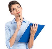 A therapist with a clipboard in hand holds a pencil to her mouth as she looks off thinking about what to write