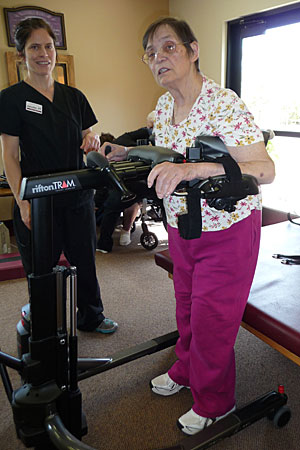 A stroke patient using a Rifton TRAM during a rehabilitation intervention session with her therapist