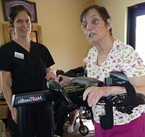 A stroke patient using a Rifton TRAM during a rehabilitation intervention session with her therapist