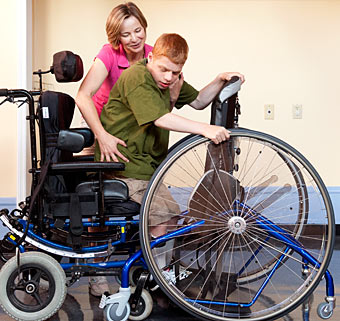 A therapist at the Woodland facility uses an activity-based curriculum to help a child with disabilities achieve positive outcomes