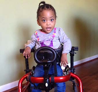 a young girl in a Rifton gait trainer