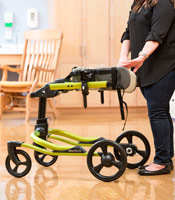 A school therapists checks that buckles and flaps on the chest prompt open easily for the student transfer. 