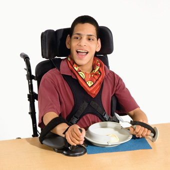 A young man eating icecream at a table