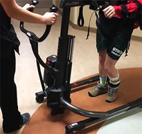 A paralyzed stroke patient uses the Rifton TRAM to learn how to walk again.