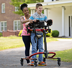young man using Rifton Pacer with prompts