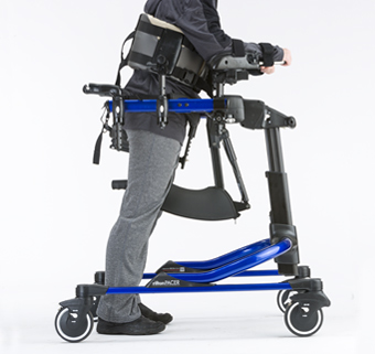 A person standing in a Rifton Pacer gait trainer in a forward-leaning position