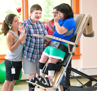 A young man standing in a Rifton Supine Stander