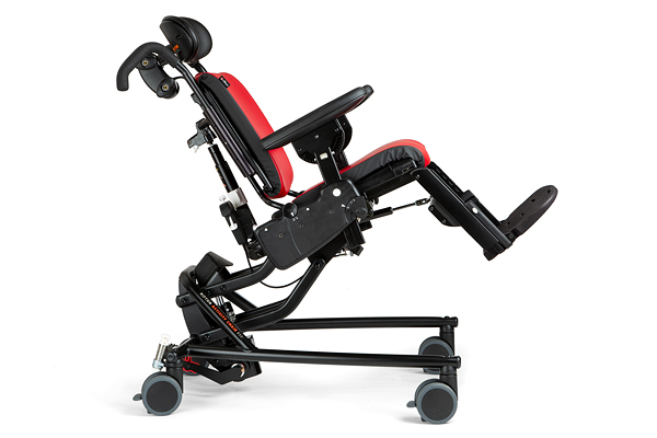 A Rifton Activity Chair with red back and seat pads, tipped back