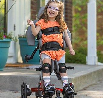 Young girl standing in Size 1 Rifton Stander