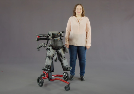 A woman demonstrates the use of a Rifton Stander.