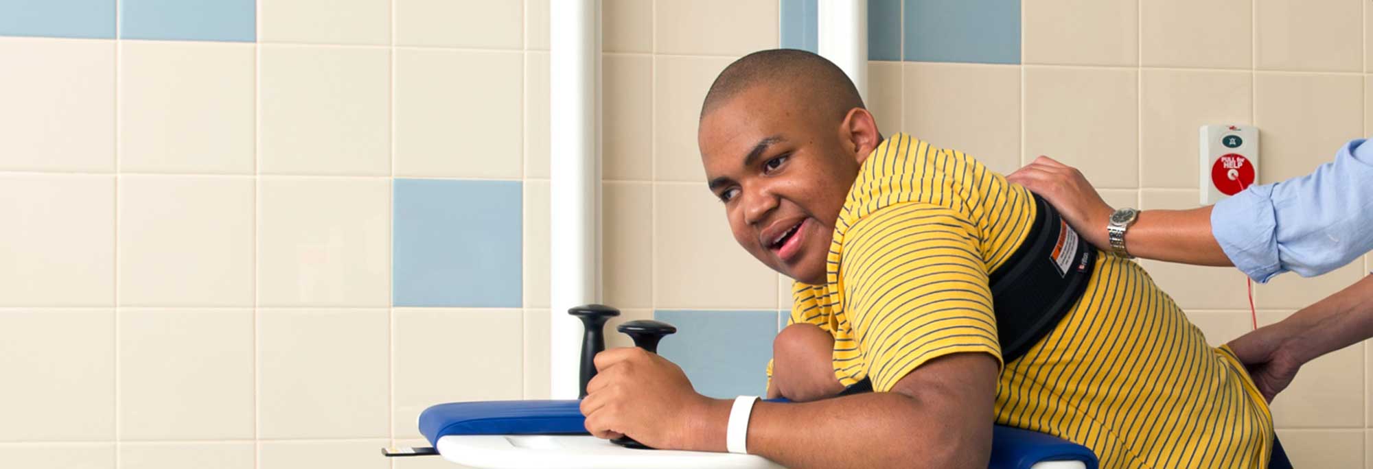 Young man using a special needs changing table