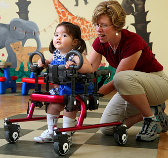 small child in mini pacer with teacher