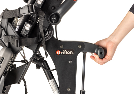 A hand shown making an adjustment on a Rifton Size 1 Stander