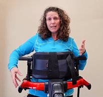Cathy Ripmaster, MS, PT, demonstrating how to adjust the chest prompt on the Rifton Pacer gait trainer
