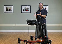 A physical therapist demonstrates the Rifton E-Pacer, a device for lifting and gait training.