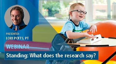 A young boy smiling in a Rifton Prone Stander.